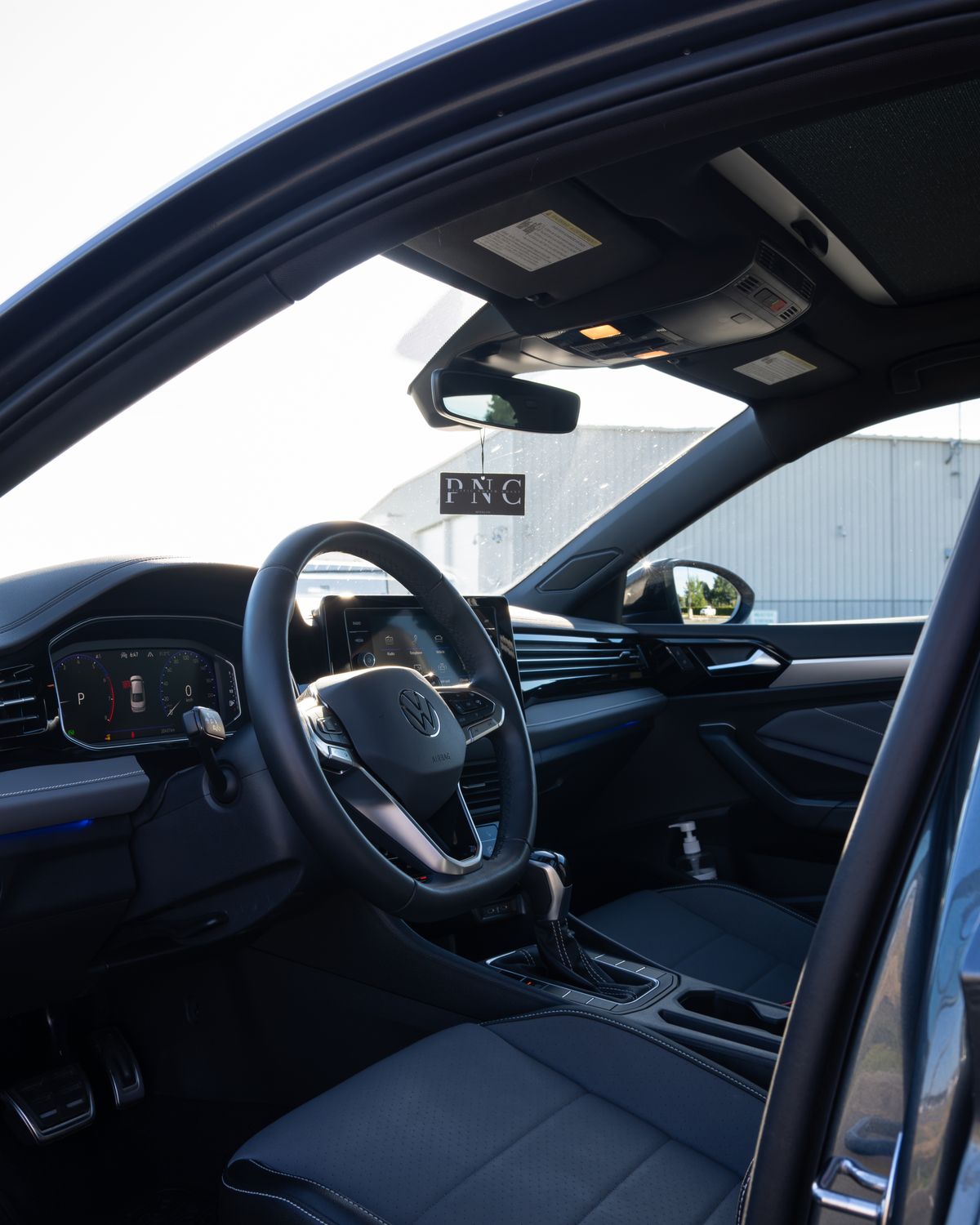 The Jetta's cockpit through the driver's door