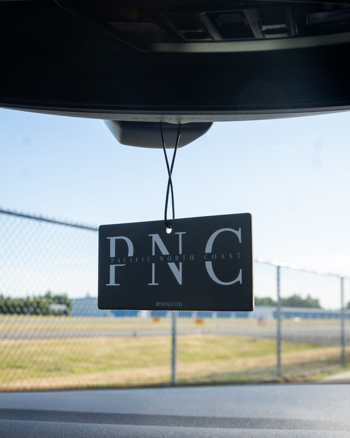 A Pacific North Coast tag hanging from the Jetta's mirror