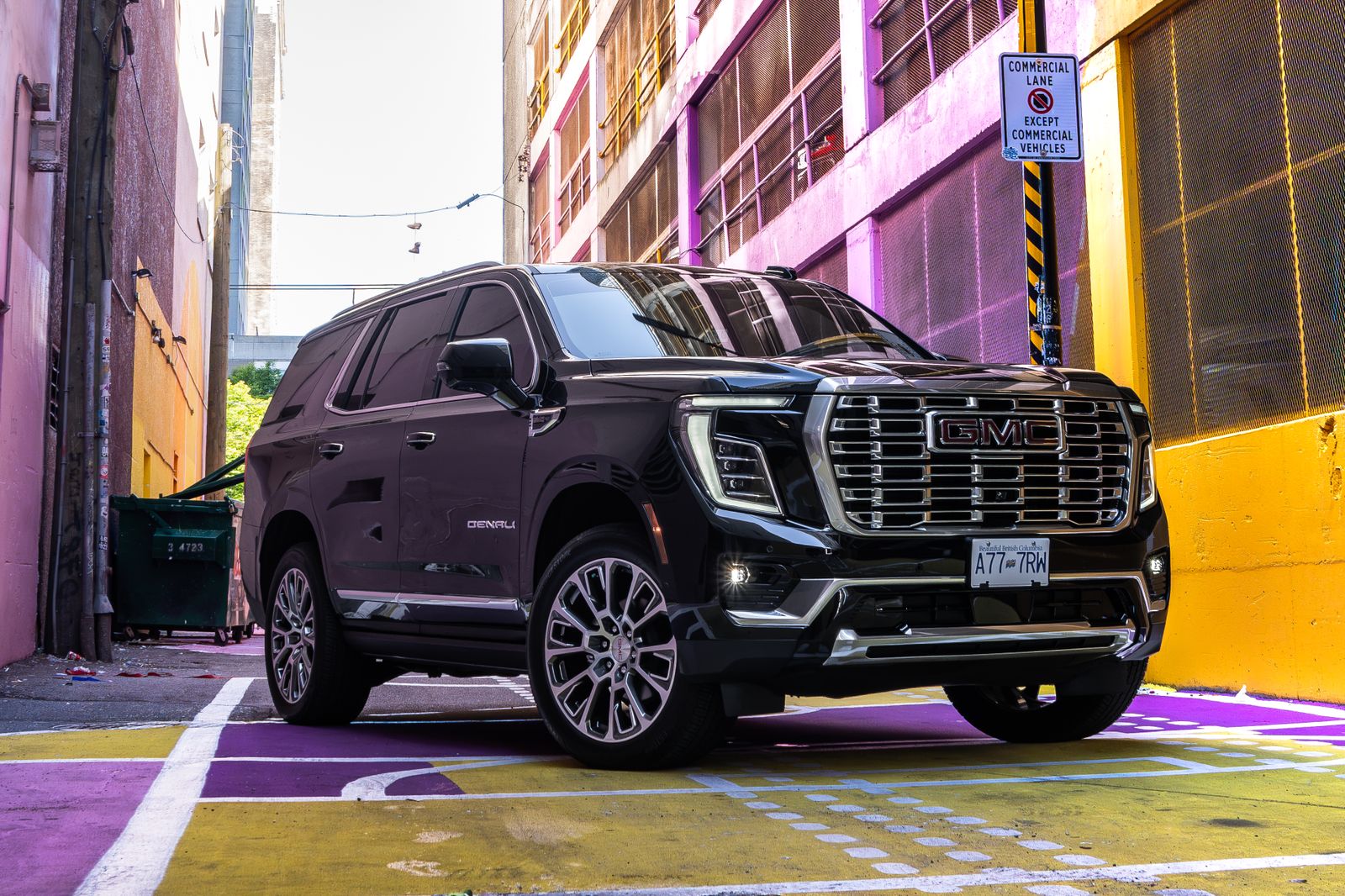 The Yukon Denali in a pink and yellow painted alley downtown