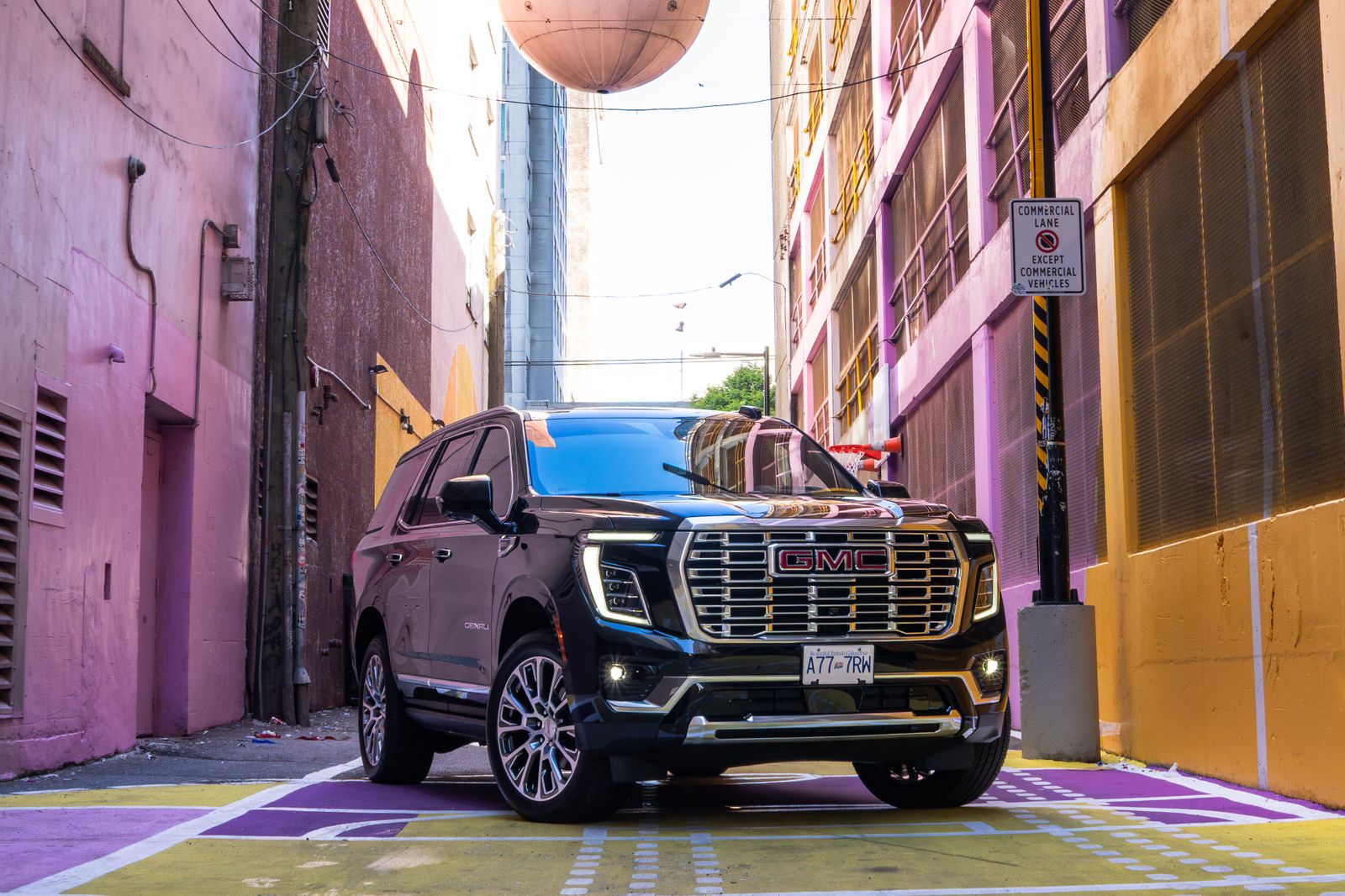 The Yukon Denali head-on between the alley's pink walls