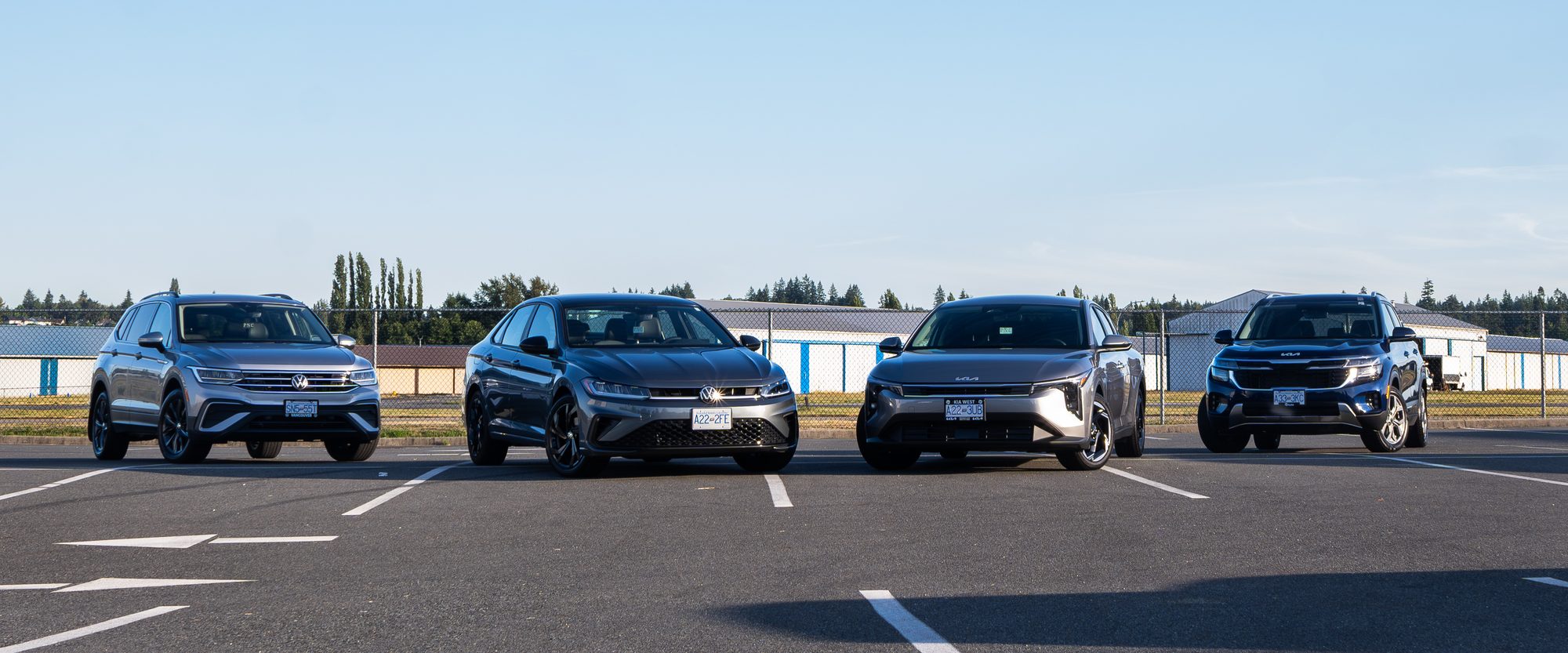 Four of the fleet side by side: a Volkswagen Tiguan, a Volkswagen Jetta, a Kia K4 and a Kia Seltos